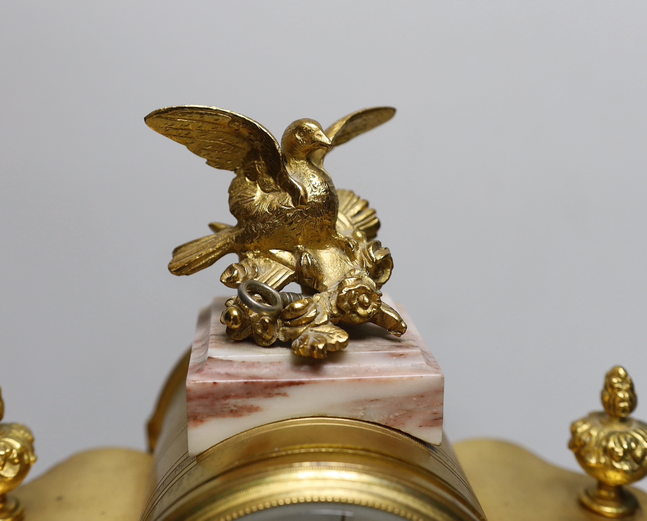 An early 20th century French gilt-metal and marble clock garniture, 38cm high